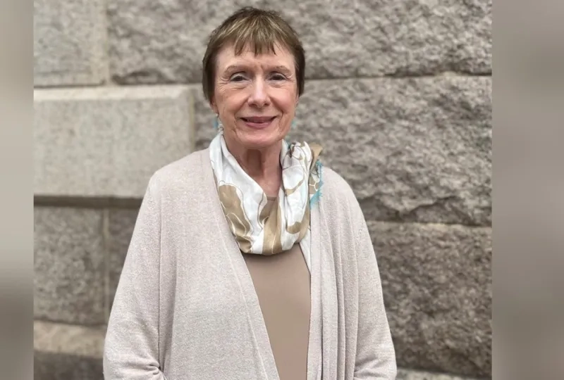 woman in front of brick wall