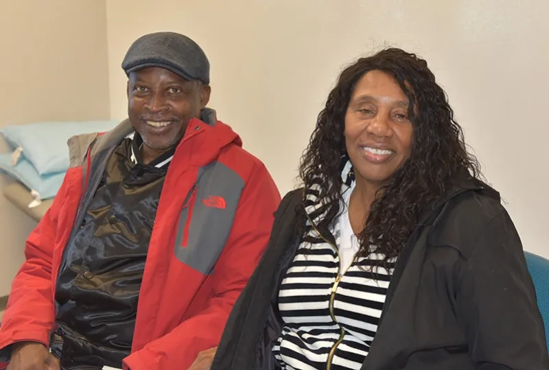A man and woman sit next to each other