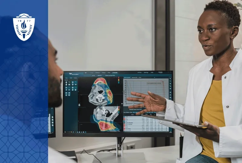 Woman wearing white lab coat standing in front of screen showing medical scans