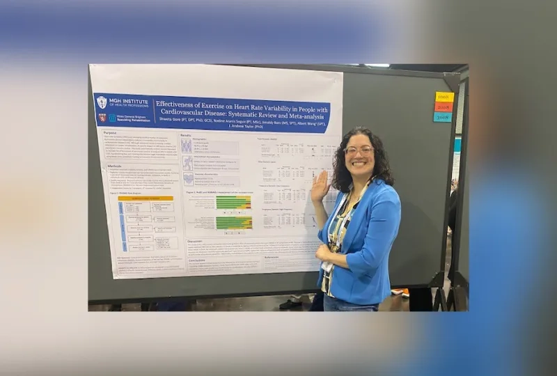 A woman stands in front of a board with a poster on it