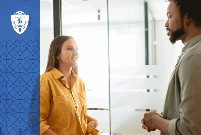 Woman wearing yellow shirt and man wearing green shirt standing in front of each other