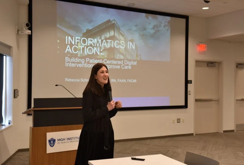 woman standing in front of a podium with a microphone