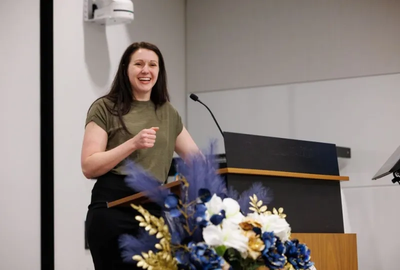 woman in front of a microphone smiling