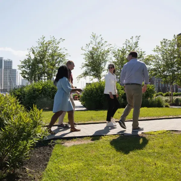 A group of people walking through a park