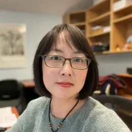 Wei Zhang in grey sweater