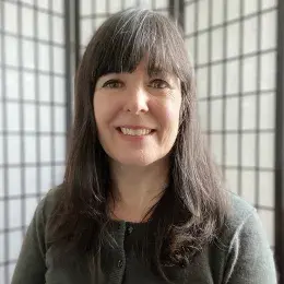 jessica has shoulder length straight brown hair and wears a black button cardigan