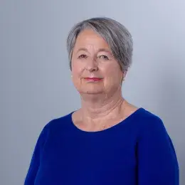 Rita Olans in blue shirt