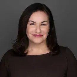 angela has dark brown eyes and hair and raspberry lipstick