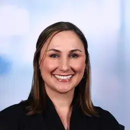 karen has a big smile and wears a black cap sleeve top