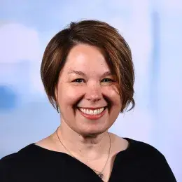 rebecca has short angled brown hair and a big smile