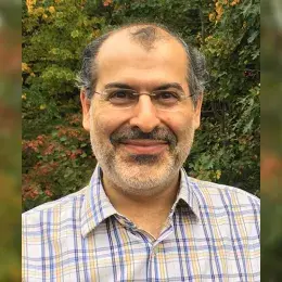 photo of pedram in front of fall foliage