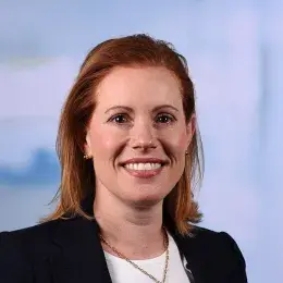 allison has red hair and wears a black blazer