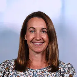 jenna has a flowered top and honey brown hair