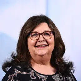 mary has shoulder length brown hair with curly flips at the end