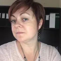 inna has short reddish hair and wears squiggly silver earrings