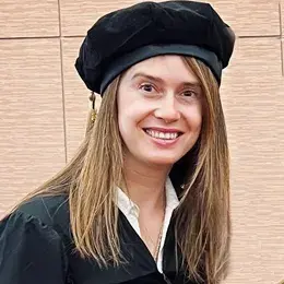 woman in cap and gown smiling