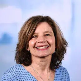 trish has a big smile and light brown hair in a bob cut