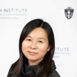 kim has a mottled black cowl neck shirt on and is Asian presenting