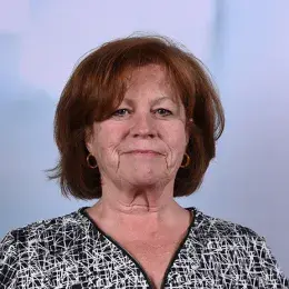 mary has red short hair and gold hoop earrings