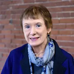 margie has close cropped reddish brown hair and light pink lipgloss