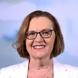 susan has a white jacket and dark pink lipstick she wears glasses