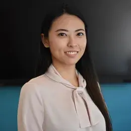 ziyi wears a beige shirt with a bow and has long straight dark hair