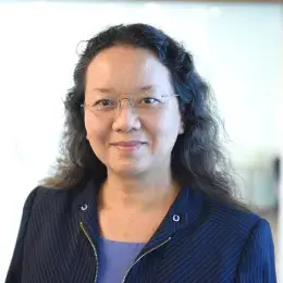 Professional portrait of an MGH IHP Doctor of Audiology faculty member in a modern indoor setting.