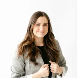 Brittany Palaski in black shirt and plaid grey blazer