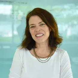 joyce stands in front of an aqua wall