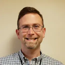 aaron has glasses and a checkered shirt