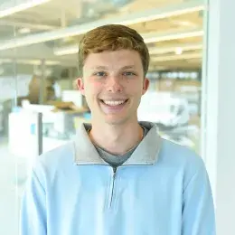 Alex Kaminsky wearing a light blue three-quarter zip up