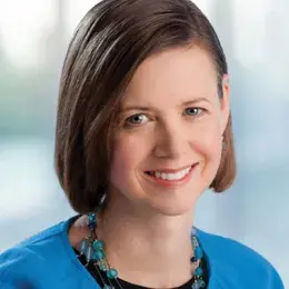 kendi wears a blue top and necklace