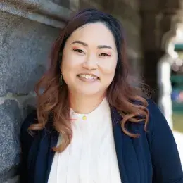 King Yan Kwok  wearing a white button up and a navy blazer