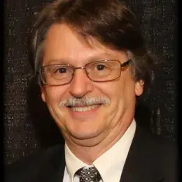 mark has a moustache and wears a suit and tie