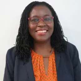 Clara has glasses and shoulder length black hair