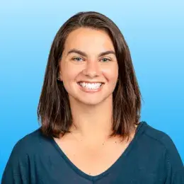 Beth Collier has straight, shoulder-length brown hair and is is wearing a dark teal shirt