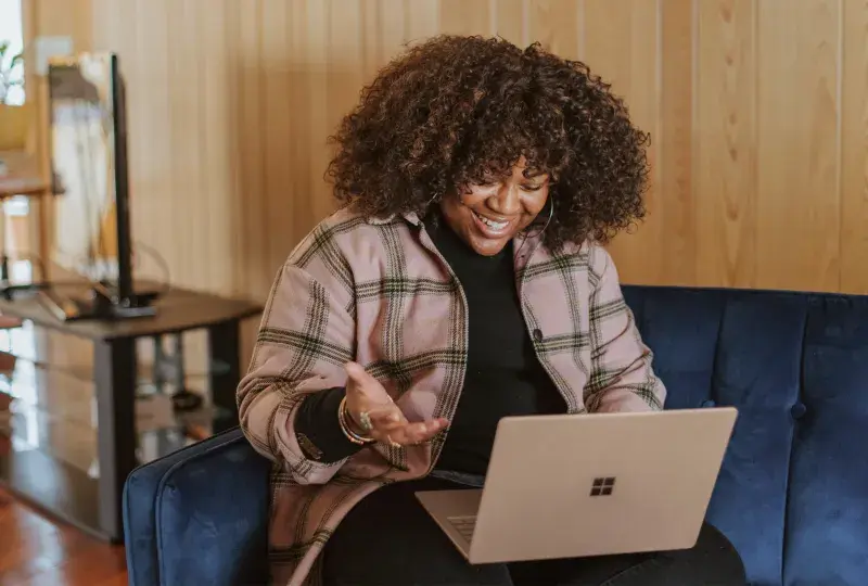 A woman having a virtual meeting on her laptop