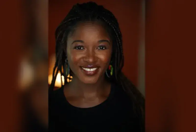 valerie wears braids and has brick red lipstick