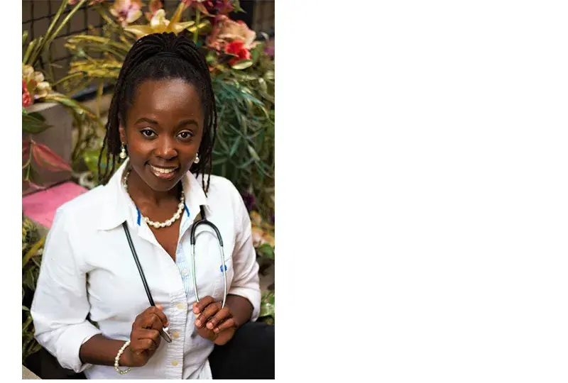 kamaria has glowing medium brown skin and wears a stethoscope 