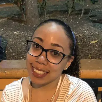 yadria has black rimmed glassses and a big smile