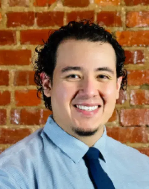 Ramiro Escalera in front of brick wall