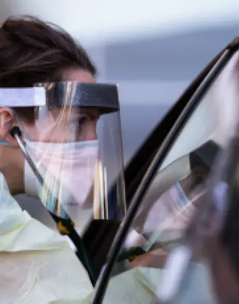 Shelby Lee Freed, MSN '11, working with a COVID-19 patient at Oregon Health & Sciences University Hospital. PHOTO: Bradley W. Parks. Courtesy of Oregon Public Broadcasting.