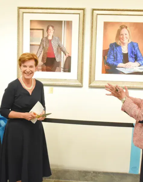 Board Chair Jeanette Ives Erickson (second from left) smiles after unveiling portraits in the new Presidents’ Hall. Also celebrating are (l-r) Trustee Jim Canfield, President Paula Milone-Nuzzo, and Chief Operating Officer Denis Stratford.