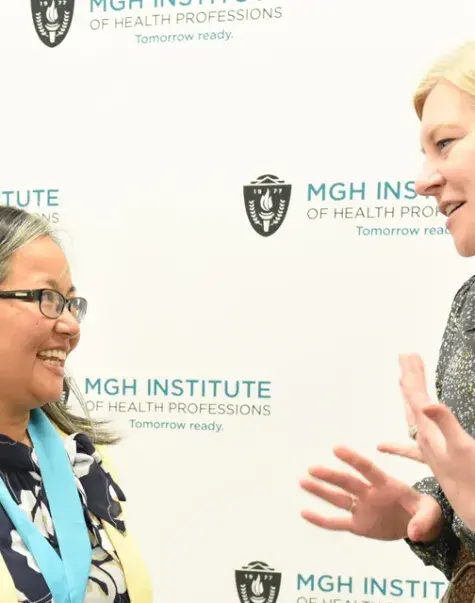 Gayun Chan-Smutko (left) talks with Genetics Counseling Chair Maureen Flynn after receiving the Nancy T. Watts Award for Excellence in Teaching.