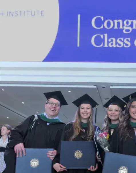 men and women in front of a 2023 sign