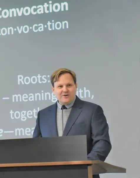 Man speaks at podium