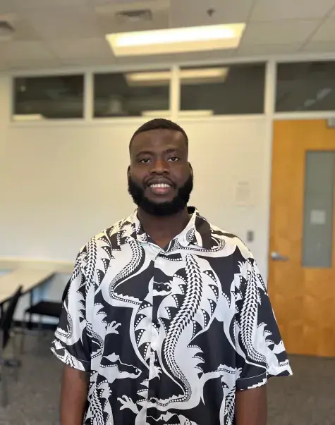student stands in classroom