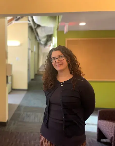woman smiles and poses in hallway