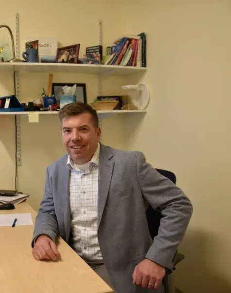 A man sits at a desk