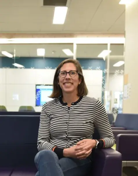 A woman sits on a couch